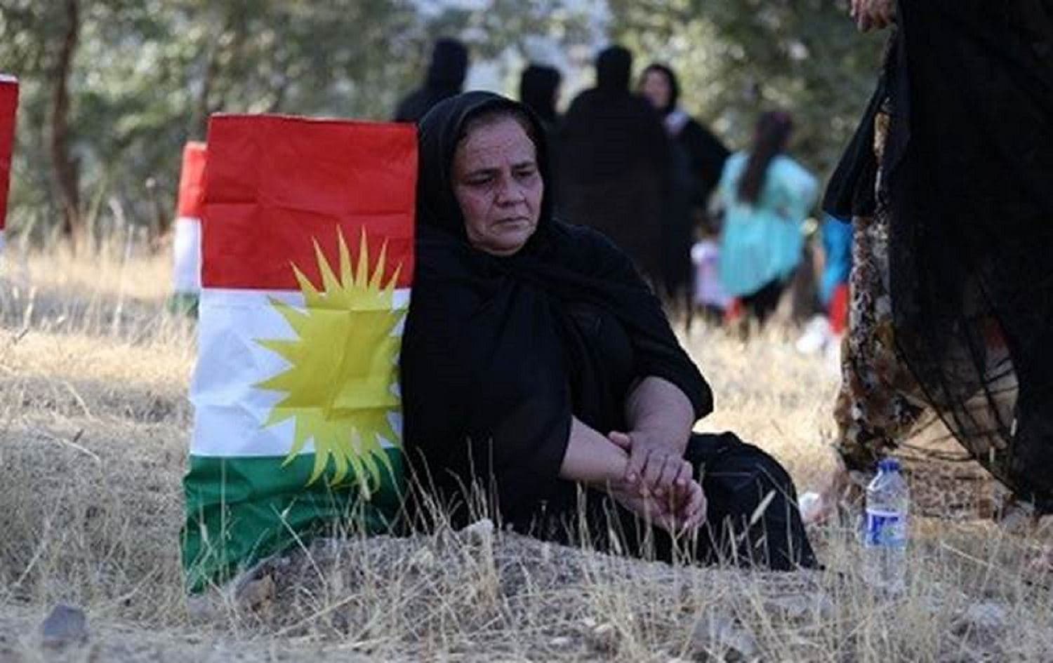 A woman sits next to a grave of an anfal victim in Barzan. File photo: Rudaw