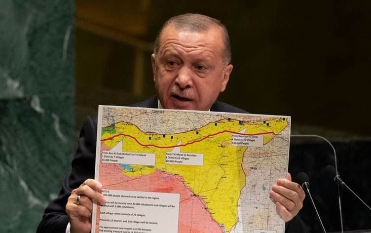 Turkish President Recep Tayyip Erdogan holds up a map of northern Syria that shows the “safe zone” Turkey wants to establish on September 14, 2019. File photo: AFP
