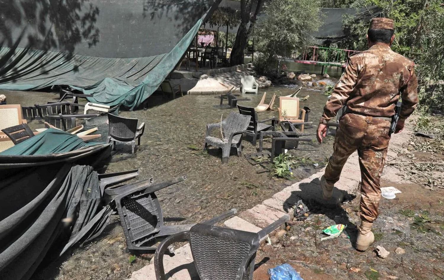 A policeman at the tourist resort in Duhok province’s Zakho that was hit with artillery shelling on July 20, 2022. Photo: Safin Hamed/AFP
