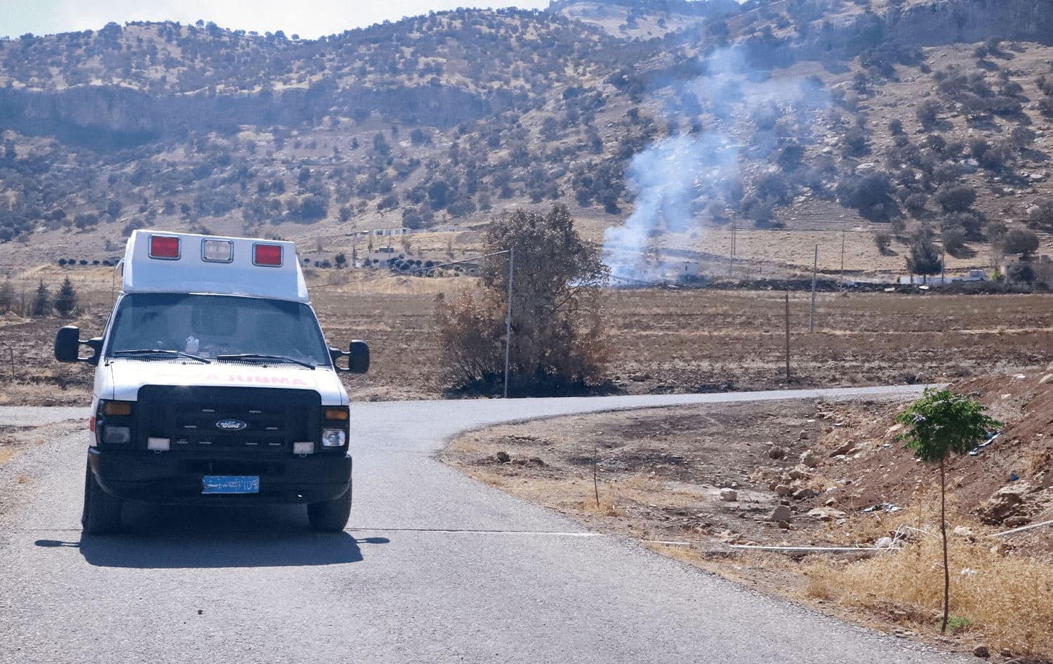Smoke billows as an ambulance drives in the area of Zargwez, Kurdistan Region, on September 28, 2022. Photo: Shwan Mohammed/AFP