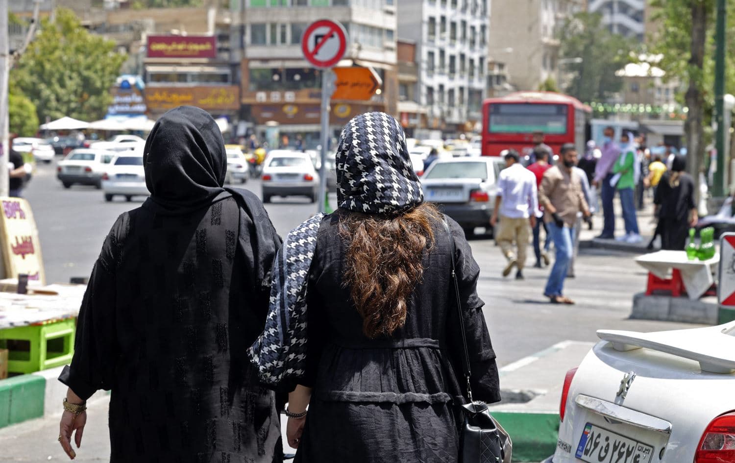 Women wearing the hijab walk in the streets of Tehran. Photo: Atta Kenare/AFP