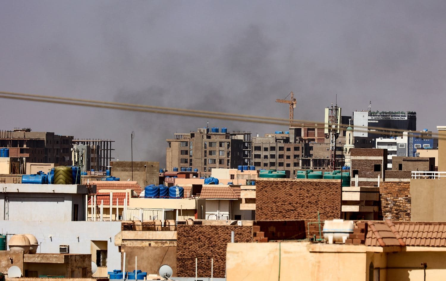 Smoke billows over residential buildings in eastern Khartoum on April 22, 2023, during ongoing battles between the forces of two rival generals. Photo: AFP