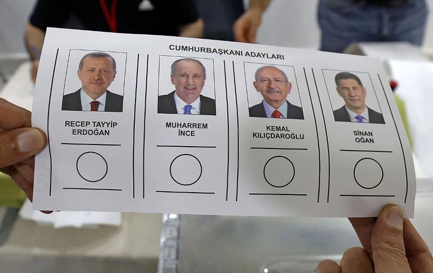A Turkish national living in Kuwait, holds a ballot bearing the images of presidential candidates, during voting for the presidential elections at the Turkish embassy in Kuwait City on May 5, 2023. Photo: Yasser al-Zayyat/AFP