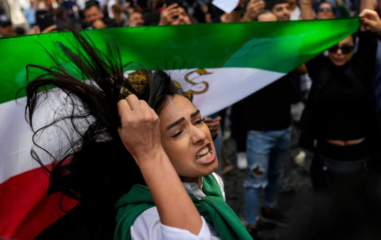 A woman shouts slogans next to an Iranian flag during a protest against the death of Iranian Mahsa Amini, outside Iran’s general consulate in Istanbul, Turkey, Wednesday, Sept. 21, 2022. Photo: Francisco Seco/AP