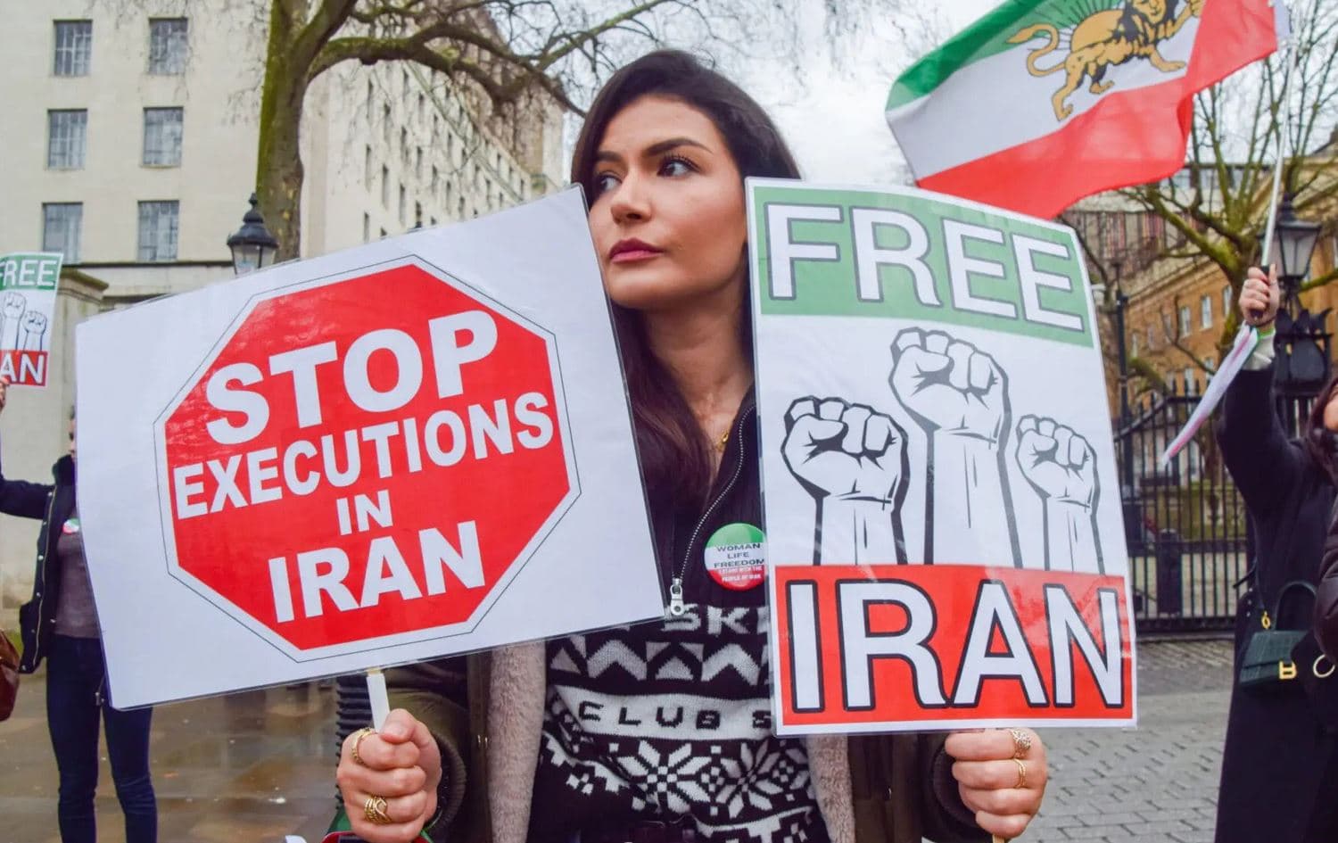A protester holds 'Stop executions in Iran' and 'Free Iran' placards during the demonstration in London, on January 14, 2023. Photo: Amnesty International