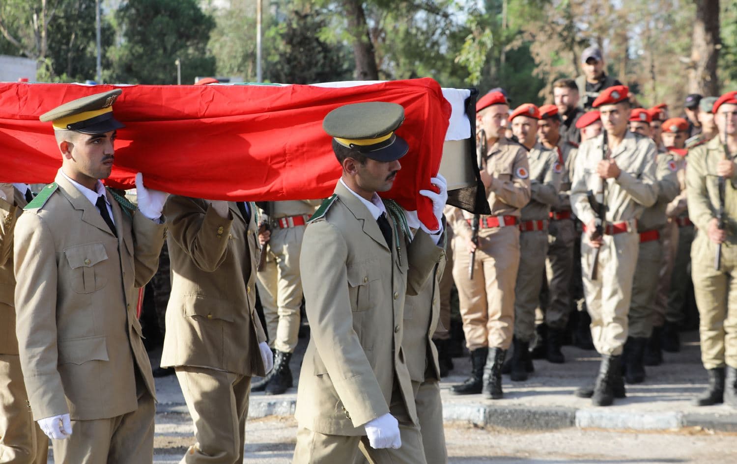 Syrian soldiers carry a casket during the funeral of the victims of a drone attack targeting a Syrian military academy, outside a hospital in government-controlled Homs on October 6, 2023. Photo: Louai Beshara / AFP