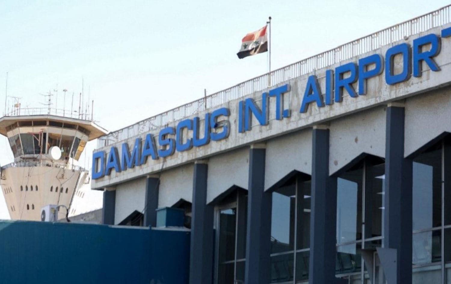 A picture shows the Syrian flag swaying in the wind at the Damascus International airport in the Syrian capital. Photo: Louai Beshara/AFP