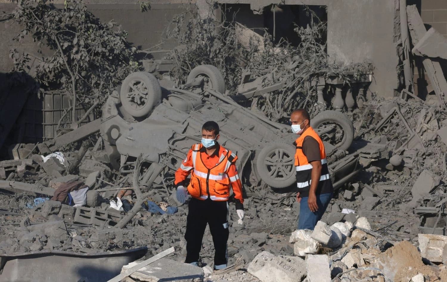 Palestinian rescuers stand on the rubble of a building following an Israeli airstrike in Rafah, in the southern Gaza Strip, on October 16, 2023. Photo: AFP