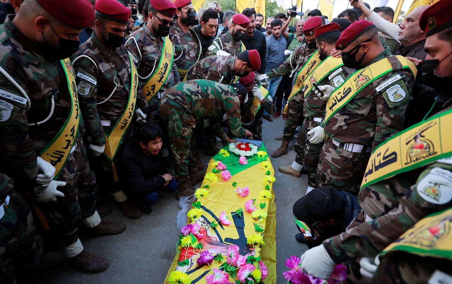 Iraqi mourners attend the funeral of Fadel al-Maksusi, a Kataeb Hezbollah fighter who was also part of the “Islamic resistance in Iraq”, the group that has claimed all recent attacks against US troops in Iraq and Syria, in Baghdad on November 21, 2023. Photo: Ahmad al-Rubaye/AFP