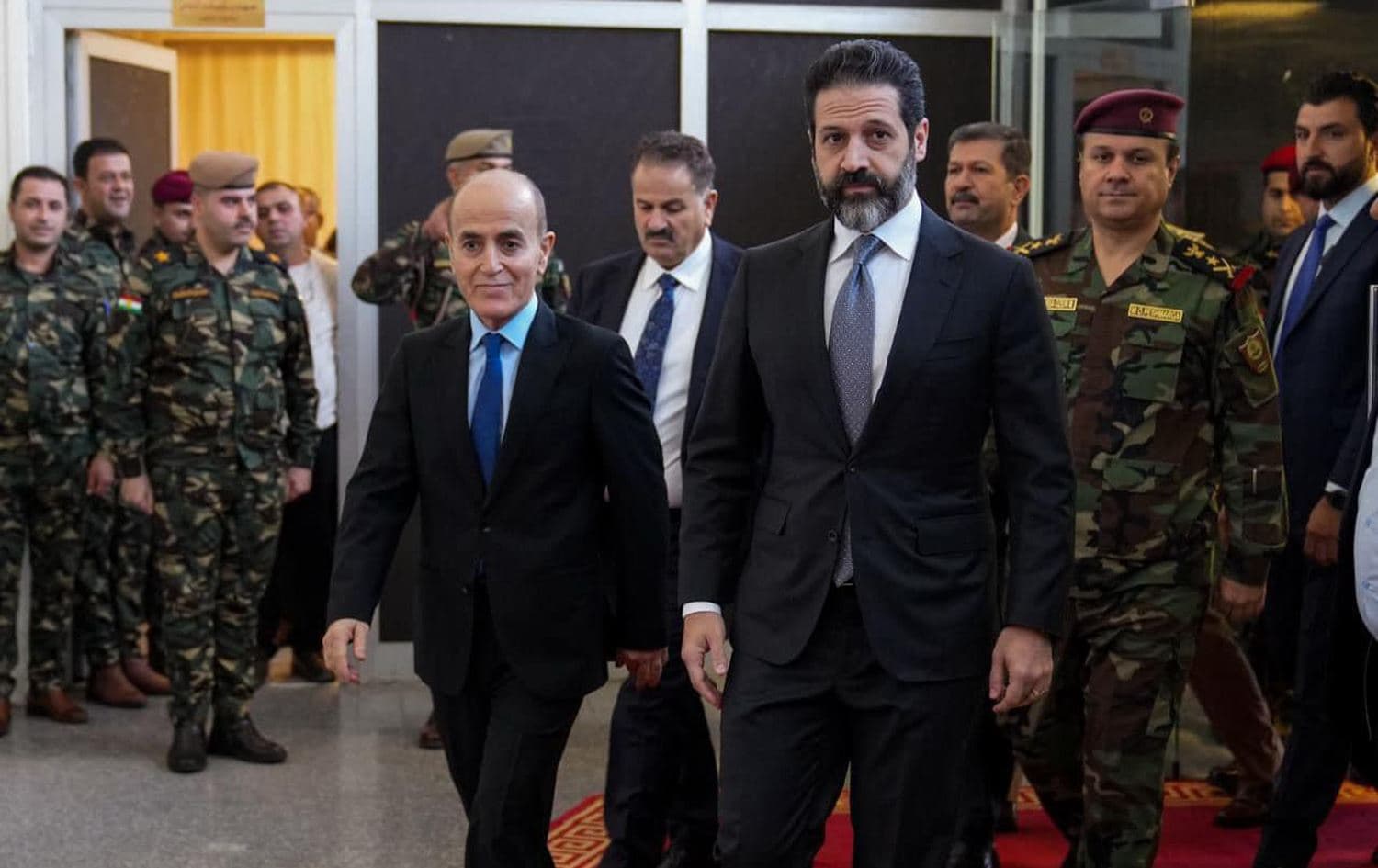 Kurdistan Region Deputy Prime Minister Qubad Talabani (right) accompanies Peshmerga Minister Shoresh Ismail back into the ministry's building on November 27, 2023, after a year-long absence. Photo: KRG