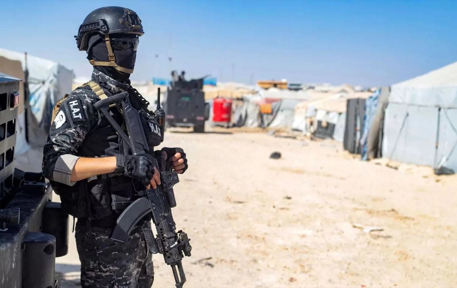 A member of the Syrian Kurdish Asayish security forces stands guard during an inspection of tents at al-Hol camp on August 28, 2022. Photo: AFP