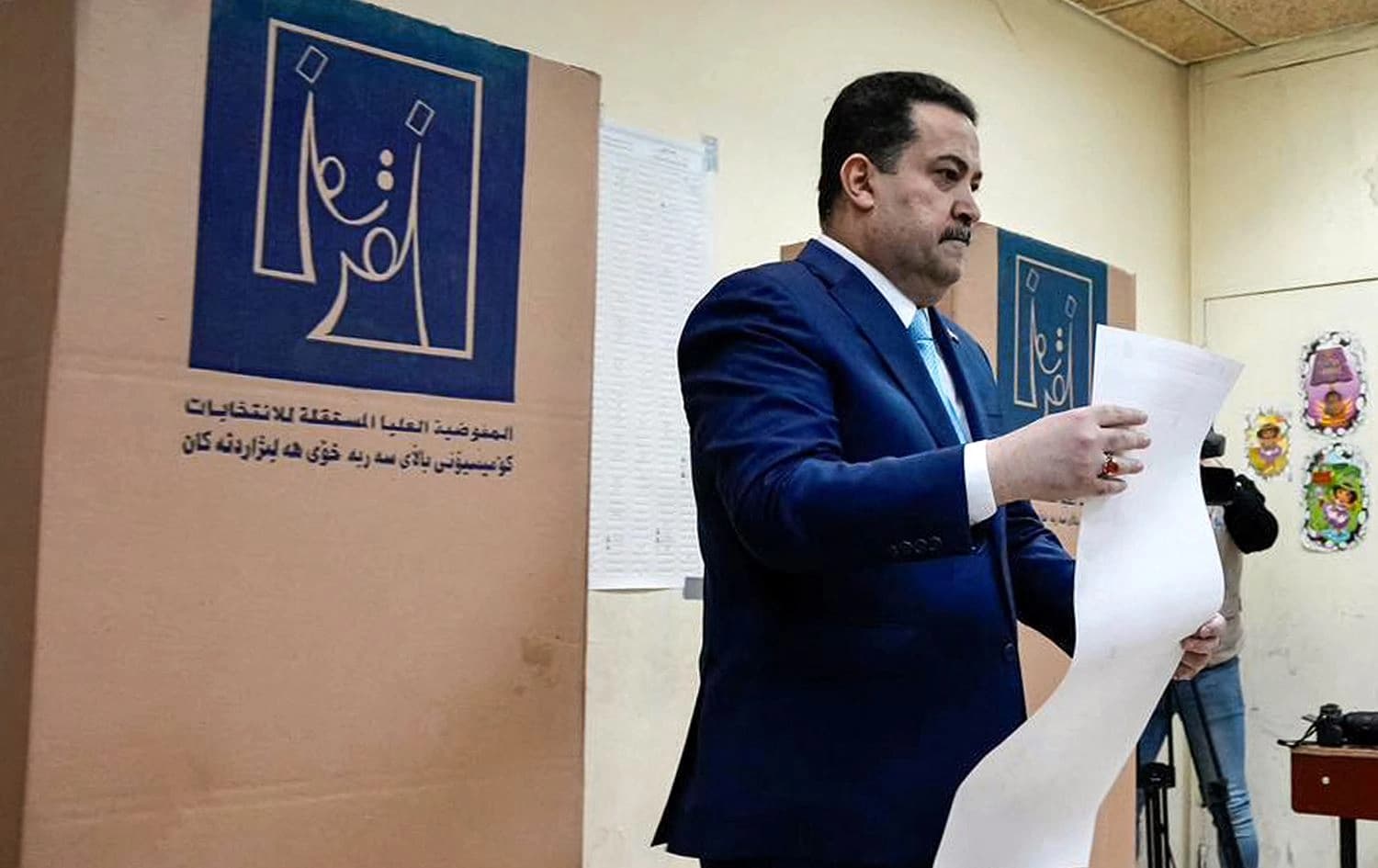 Iraqi Prime Minister shows Prime Minister Mohamed Shia al-Sudani holding his ballot at a polling station in Baghdad during the 2023 Iraqi provincial council elections, the first such vote in a decade, on December 18, 2023. Photo: PM Sudani’s office