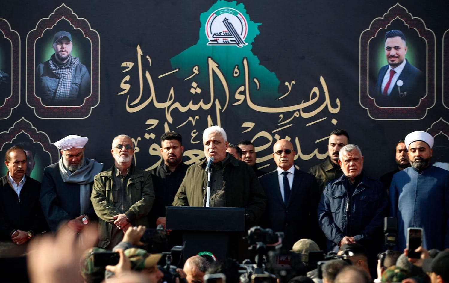 Falih al-Fayyadh (center), head of Iraq's Iran-aligned Popular Mobilization Forces (PMF, or Hashd al-Shaabi), speaks during the funeral of people killed the previous day in US strikes in western Iraq, in Baghdad on January 4, 2024. Photo: Ahmad al-Rubaye/AFP