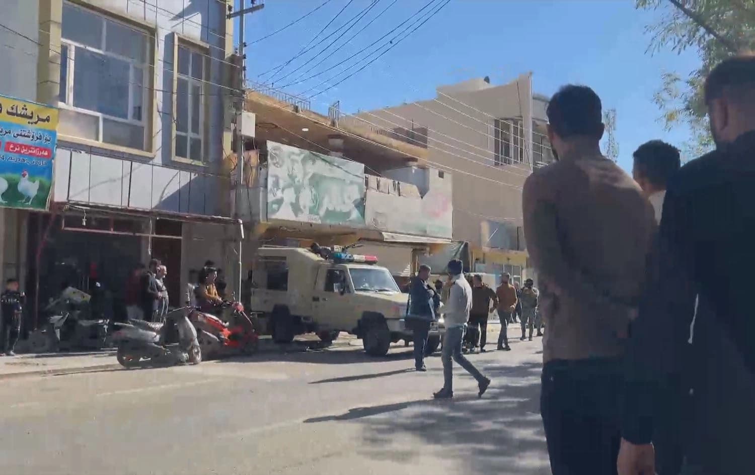 Security forces and people gathered in front of a building that was targeted with a drone in Garmiyan administration's Kalar on March 1, 2024. Photo: Rudaw