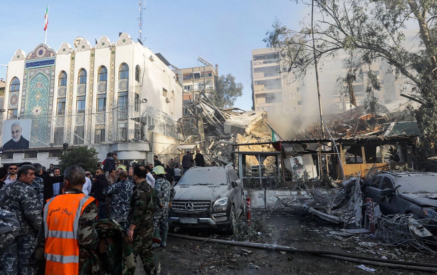 Emergency and security personnel inspect the site of strikes which hit a building annexed to the Iranian embassy in Syria's capital Damascus, on April 1, 2024. Photo: Louai Beshara/AFP