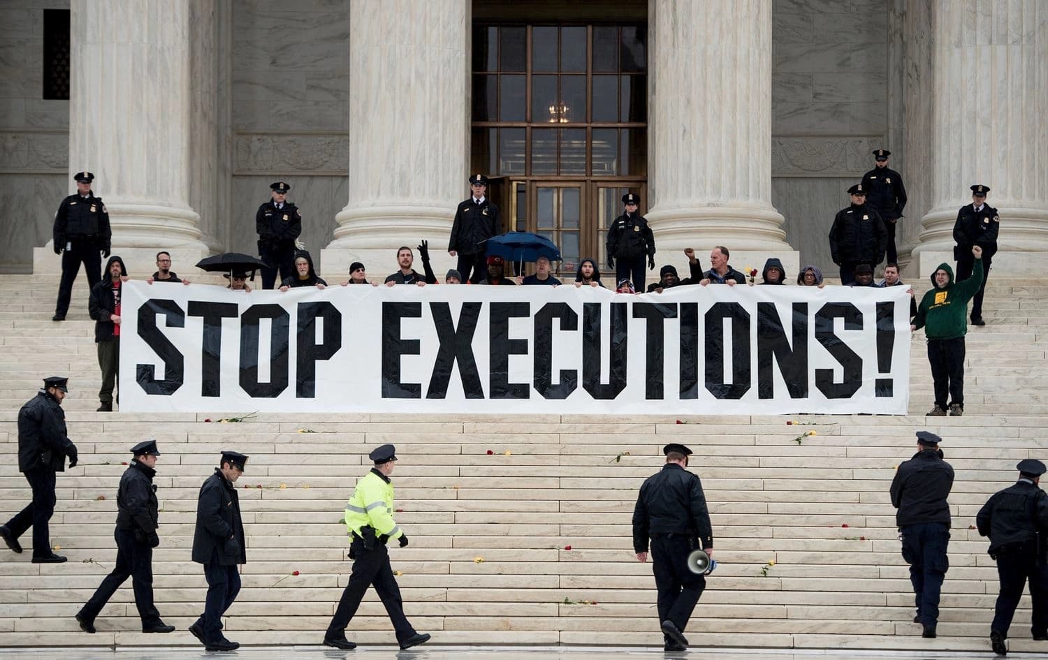 Police officers gather to remove activists during an anti death penalty protest in front of the US Supreme Court. Photo: Brendan Smialowski/AFP
