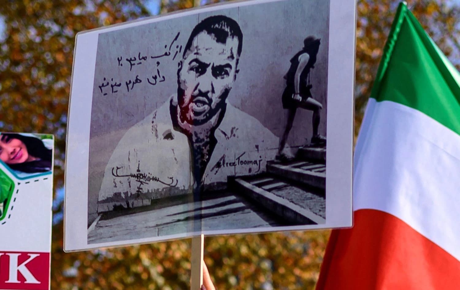 People hold placards bearing portraits of Iranian rapper Toomaj Salehi, during a rally in support of Iranian women in Istanbul, Turkey on November 26, 2022. Photo: Yasin Akgul/AFP