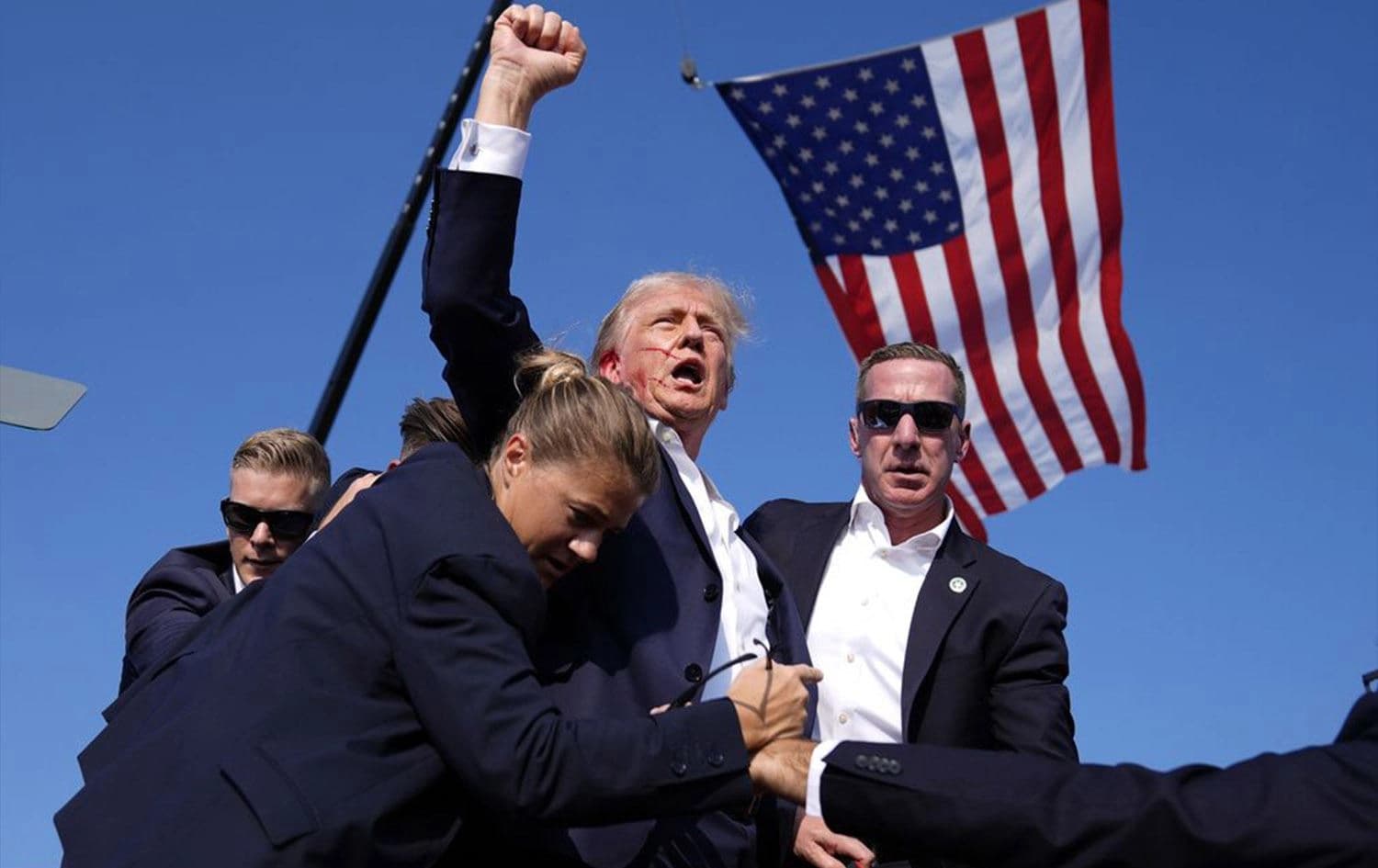 Former US President Donald Trump, the presumptive Republican presidential candidate, is surrounded by US Secret Service agents at a campaign rally, Saturday, July 13, 2024, in Butler, Pennsylvania. Photo: Evan Vucci/AP