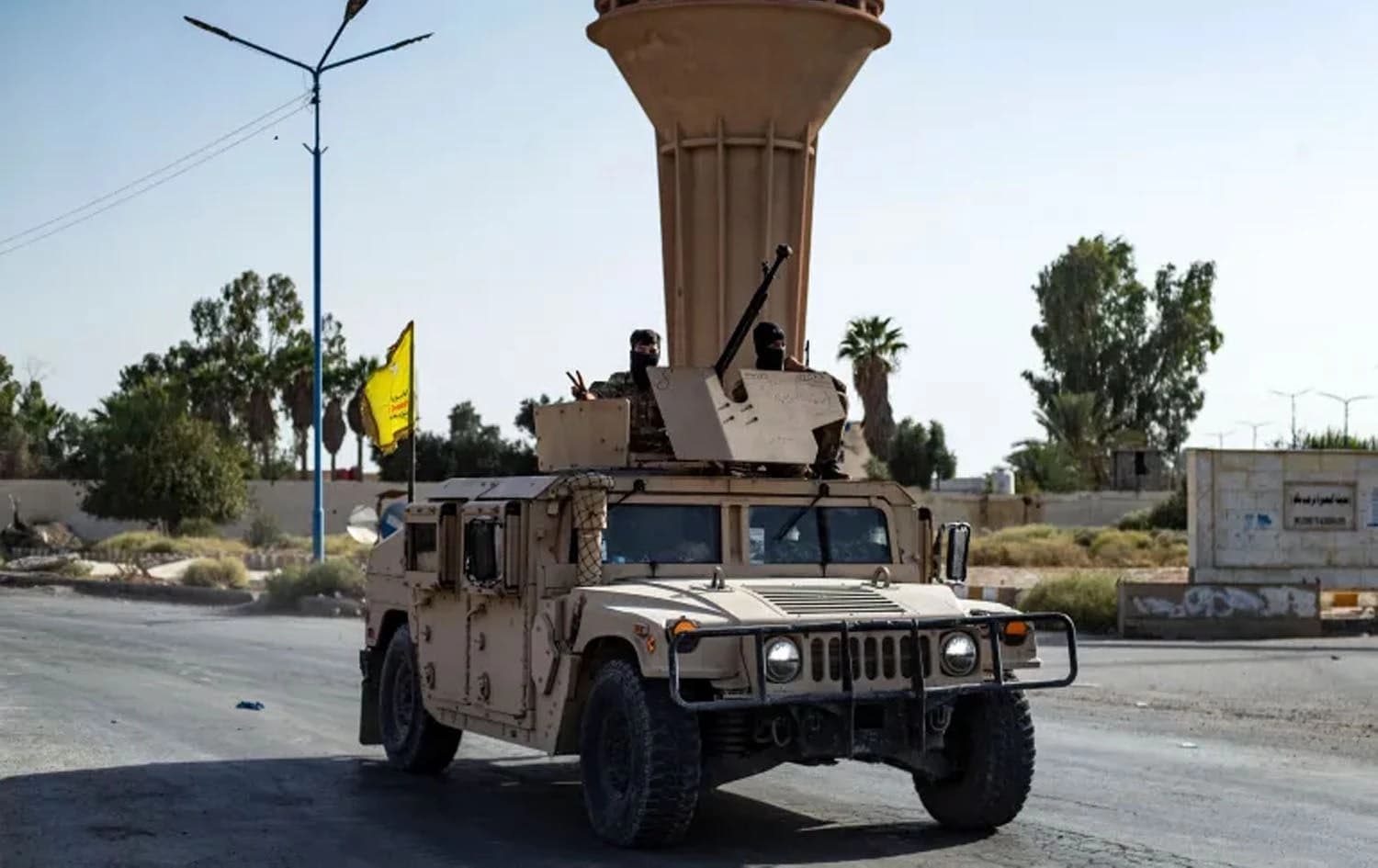 An SDF vehicle patrols as fighters impose a curfew on al-Busayrah in Deir Az Zor province on September 4, 2023. Photo: Delil Souleiman/AFP