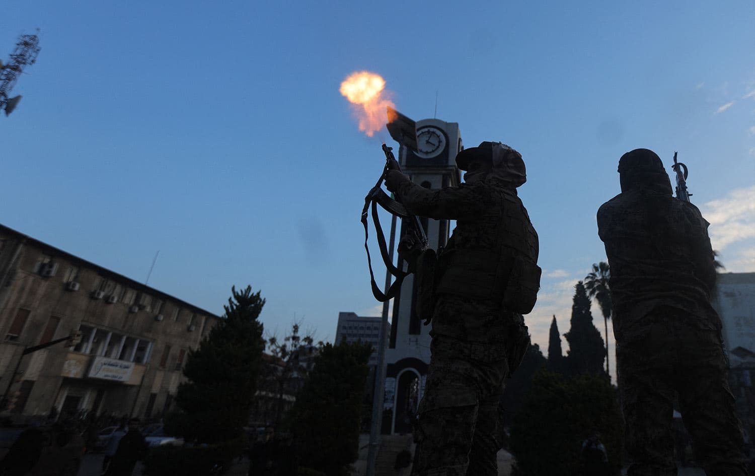 A Syrian anti-government rebel fighter fires in the air during celebrations in the central city of Homs early on December 8, 2024. Photo: Bakr Alkasem/AFP