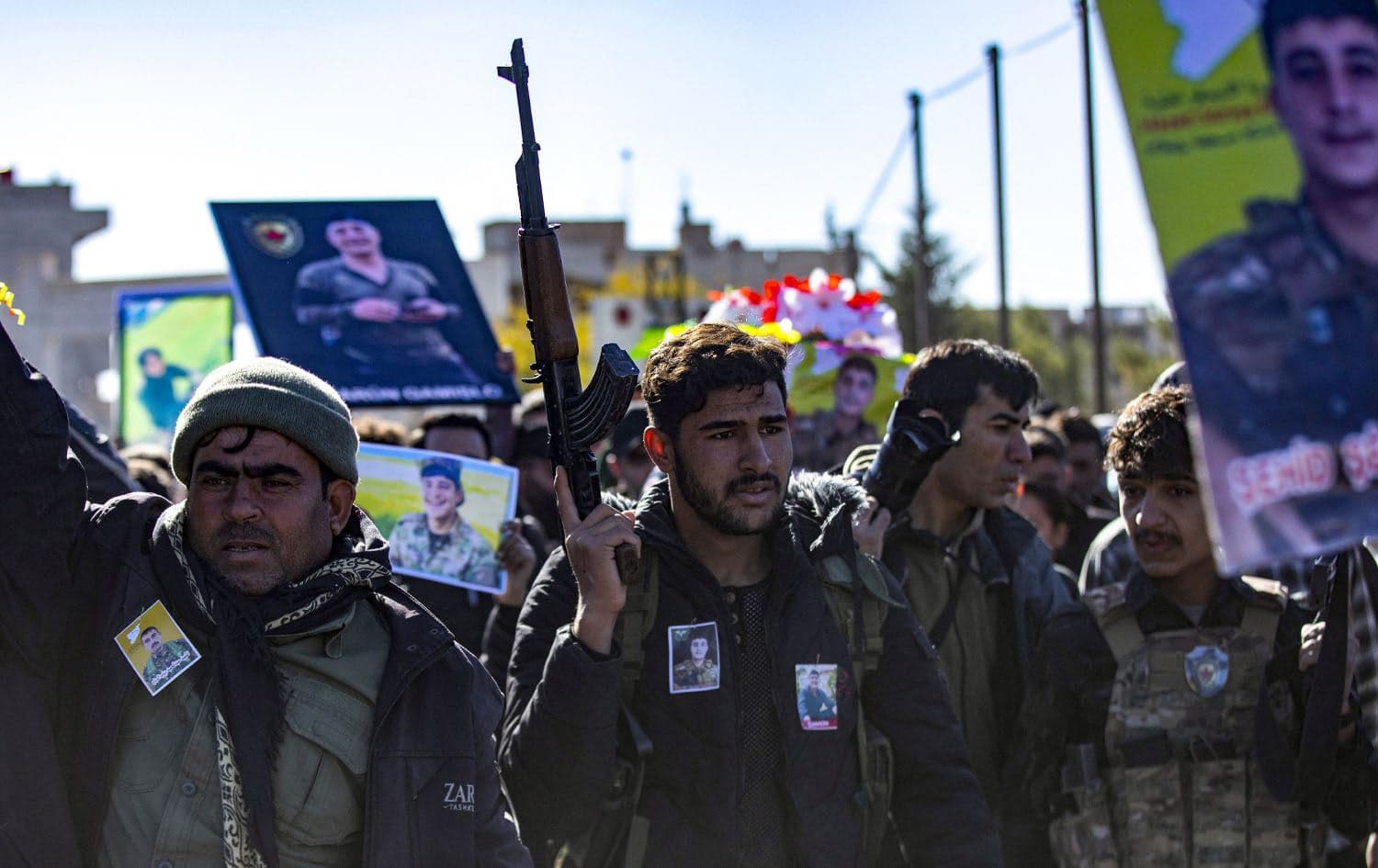 Comrades attend the funeral of five fighters of the Kurdish-led Syrian Democratic Forces (SDF) who were killed in Manbij during clashes with Turkish-backed opposition factions earlier this week, in Qamishli in northeastern Syria on December 14, 2024. Photo: Delil Souleiman/AFP