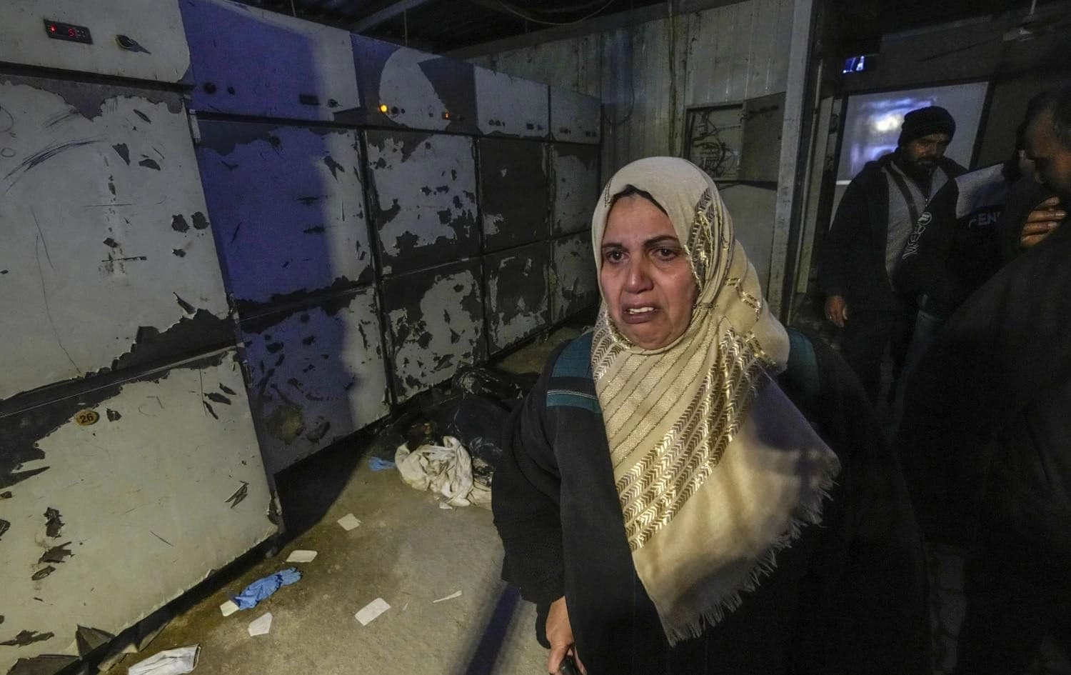 A woman leaves the morgue at Al-Mojtahed hospital in Damascus, Syria, on December 11, 2024. Photo: Hussein Malla/AP