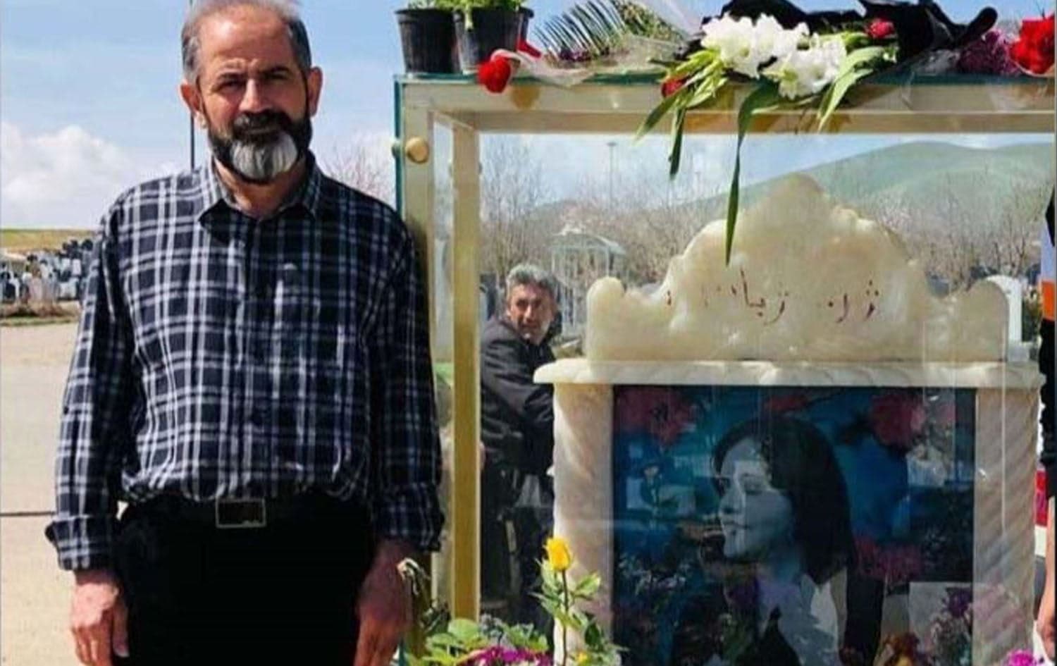 Amjad Amini stands by the grave of his daughter Zhina (Mahsa) Amini, whose death sparked Iran’s Woman, Life, Freedom revolution, in Saqqez. File photo: Kurdistan Human Rights Network