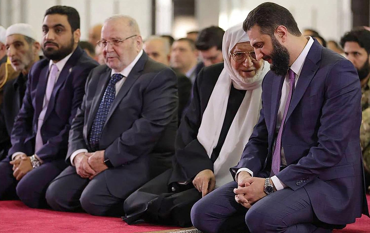 Syria's interim President Ahmed al-Sharaa (right) listening to the country's new Grand Mufti Sheikh Osama al-Rifai (second right)during the the Eid al-Fitr morning prayer at the People's Palace in Damascus on March 31, 2025. Photo: Sharaa’s office/Telegram