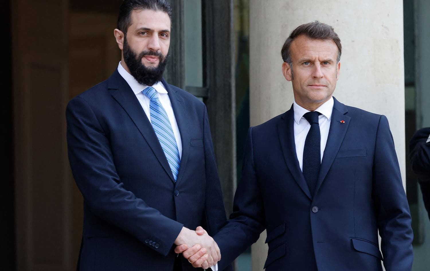 France's President Emmanuel Macron (right) greets Syrian interim President Ahmed al-Sharaa (left) upon his arrival for their meeting at the Elysee presidential palace in Paris on May 7, 2025. Photo: Ludovic Marin/AFP