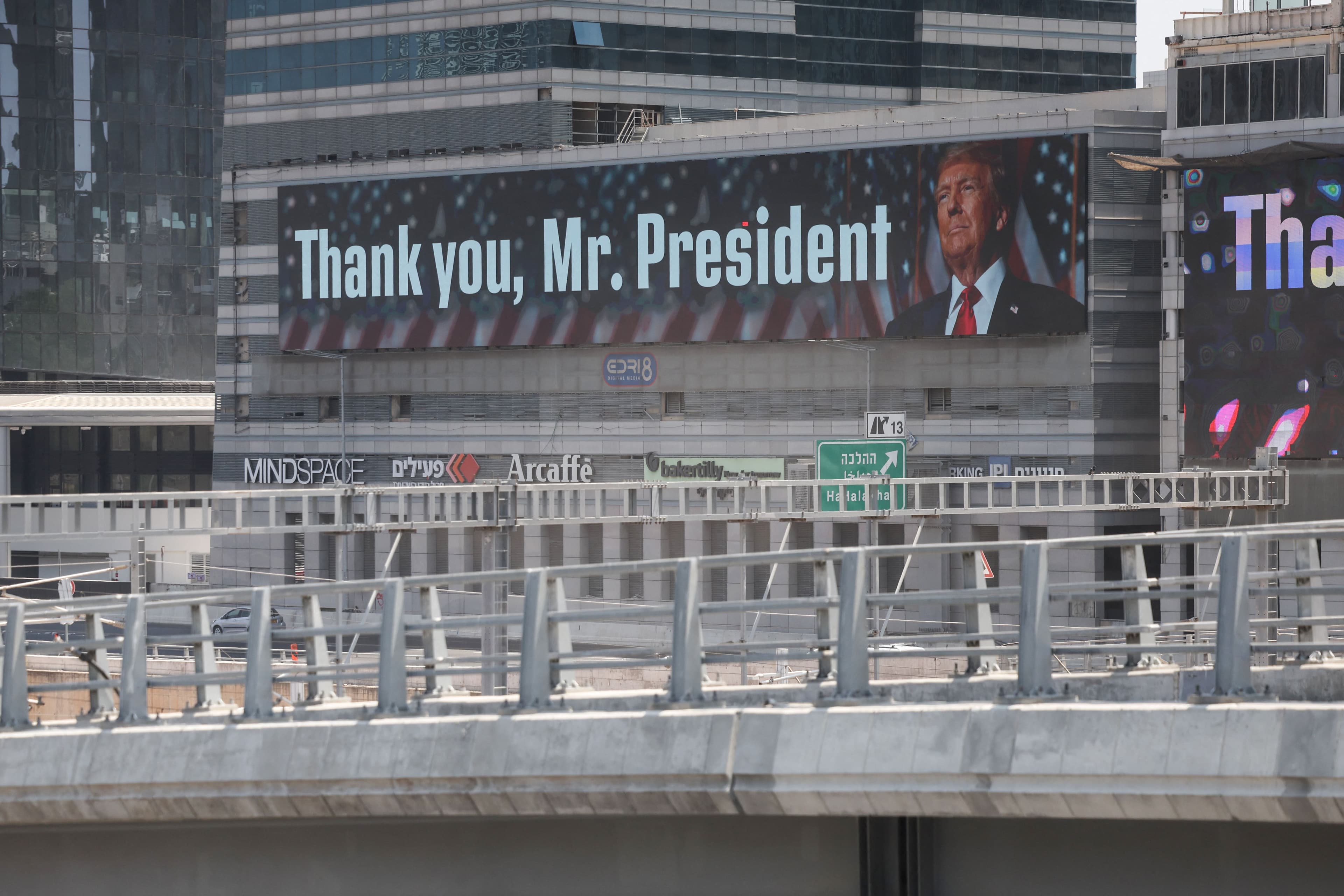 A banner bearing a picture of US President Donald Trump accompanied by a message, is displayed in Tel Aviv on June 22, 2025. Photo: AFP