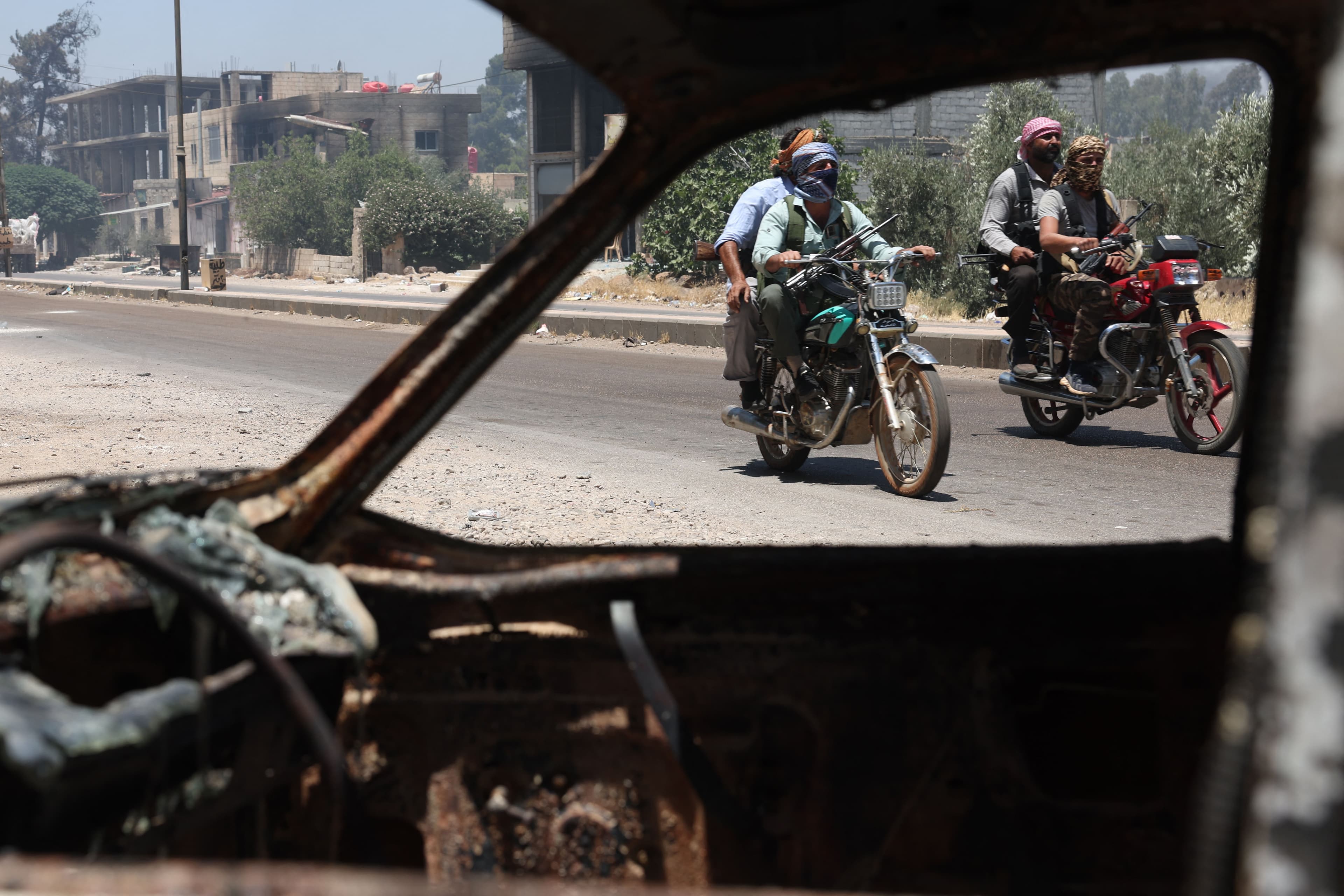 Tribal and bedouin fighters cross the al-Mazraa village in Syria's Suwayda province as they mobilise amid clashes with Druze gunmen on July 18, 2025. Photo: AFP 