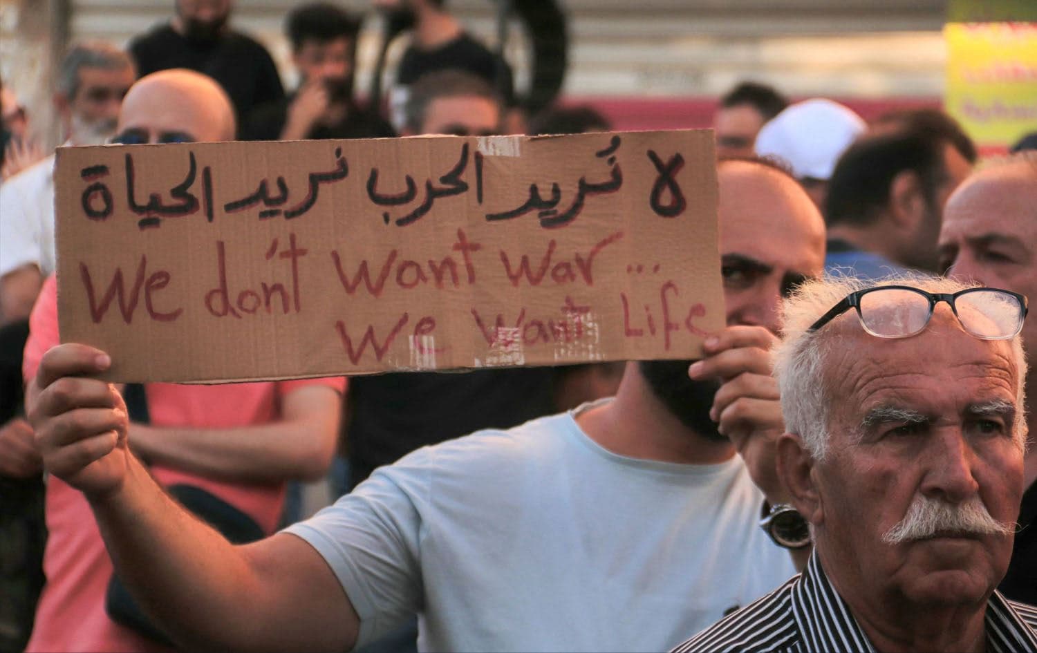 A Syrian carries a placard during a protest of the humanitarian situation in the Druze majority city of Suwayda on July 28, 2025. Photo: Shadi al-Dubaisi/AFP