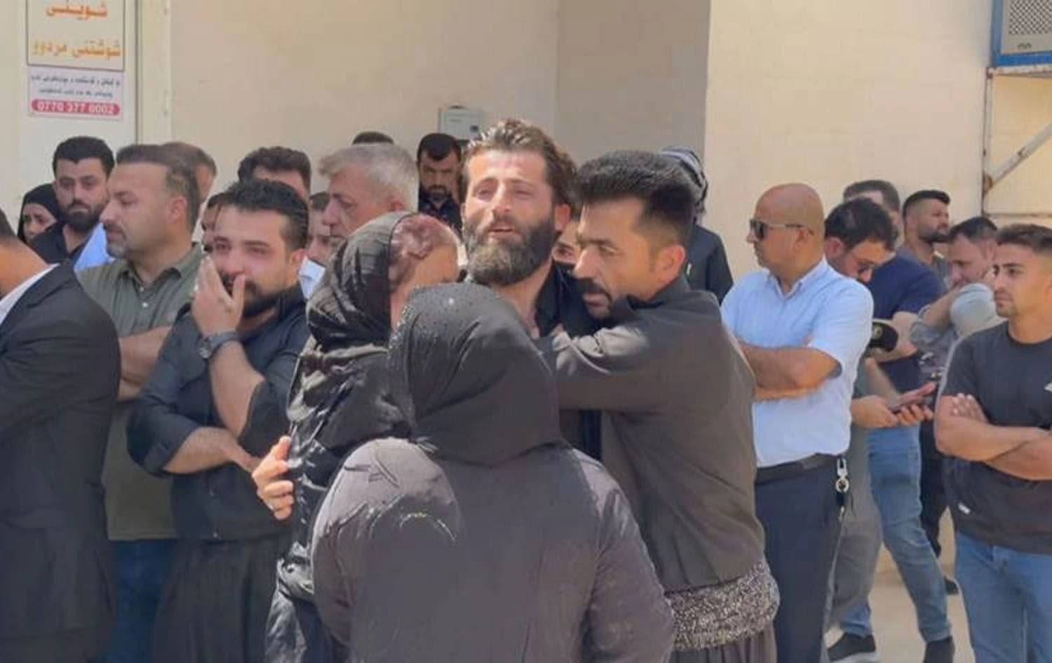 The family of Bashdar Hassan wait to receive his body in Ranya, Kurdistan Region on August 14, 2025. Photo: Screengrab/Rudaw