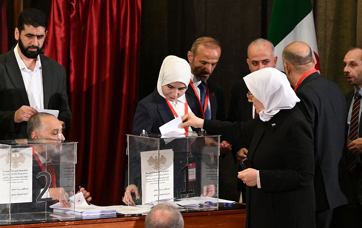 A member of Syria's local committees casts her vote in the country's selection process to designate an interim parliament, in Damascus on October 5, 2025. Photo: Louai Beshara/AFP