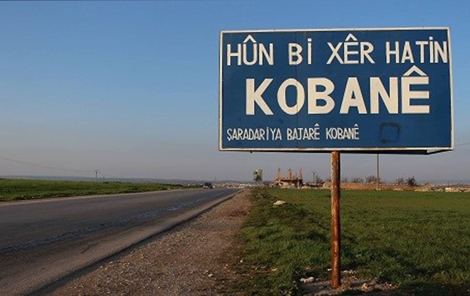 A billboard on the outskirts of Kobane in northeast Syria (Rojava) reads: 'Welcome to Kobane, the municipality of Kobane' on February 25, 2019. Photo: Hannah Lynch / Rudaw