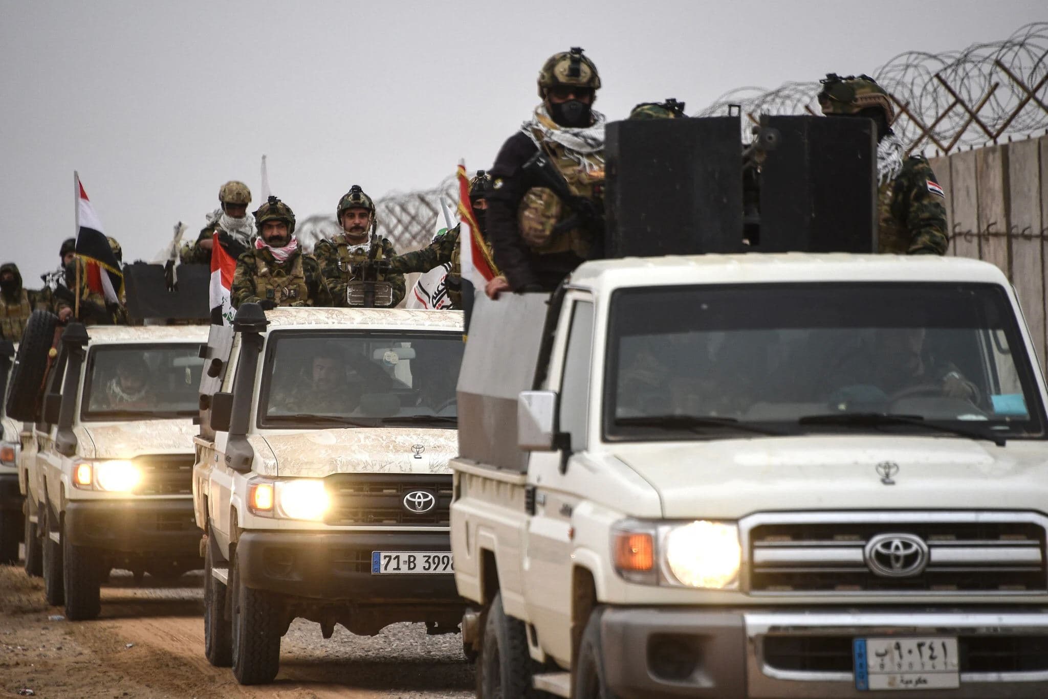 Members of the Iraqi Popular Mobilization Forces (PMF) drive along the border with Syria in the Tarfawi area of northwestern Iraq on January 22, 2026. AFP file photo