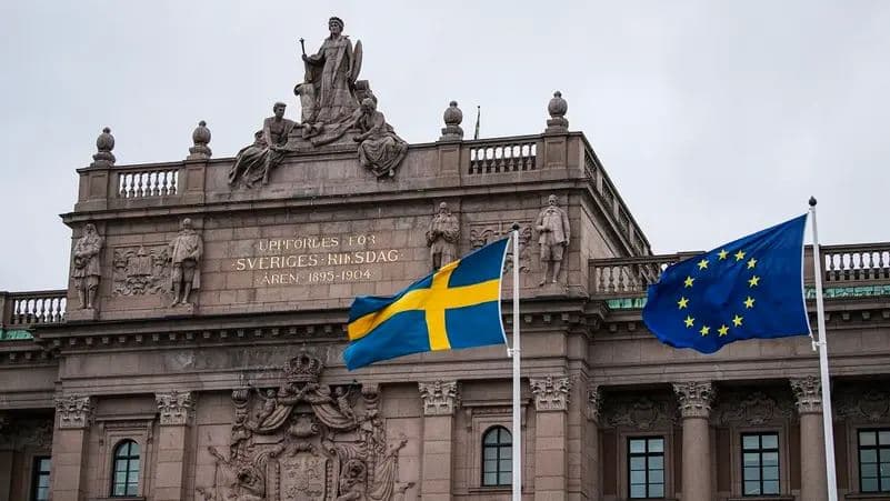 The Swedish and EU flags fly in front of the Swedish Parliament in April 2020 in Stockholm. Photo: AFP