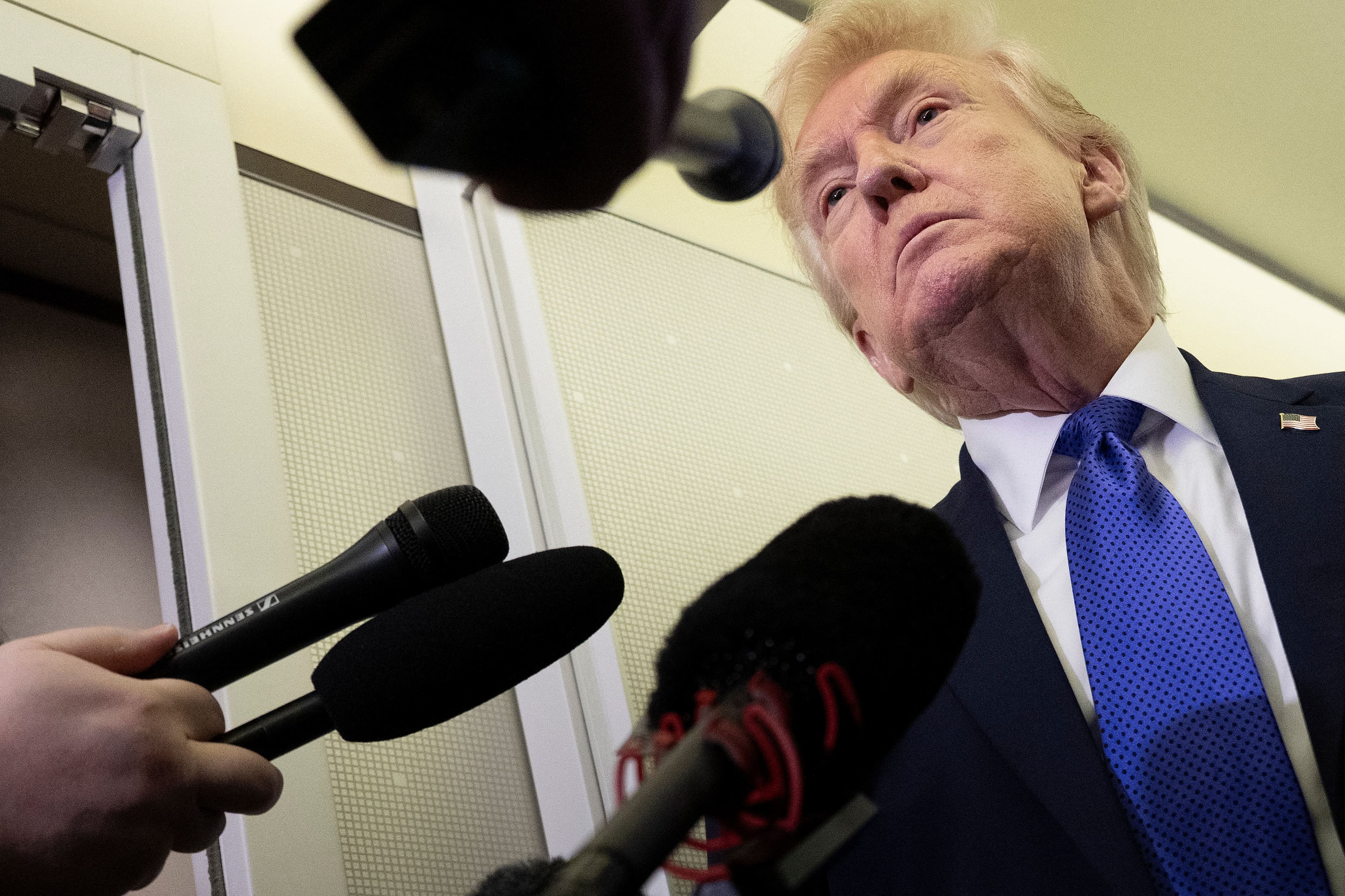 US President Donald Trump speaks with reporters aboard Air Force One on his way to Palm Beach International Airport on February 6, 2026. Photo: AFP