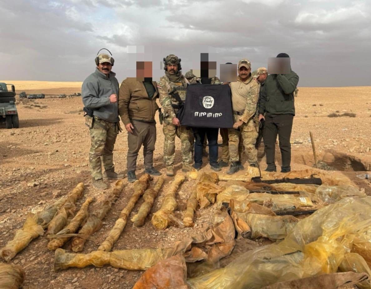 Members of the Iraqi armed forces pose with an Islamic State (ISIS) flag following a raid on one of the group’s hideouts in western Anbar province on February 5, 2026. Photo: Anbar Province Police Command.