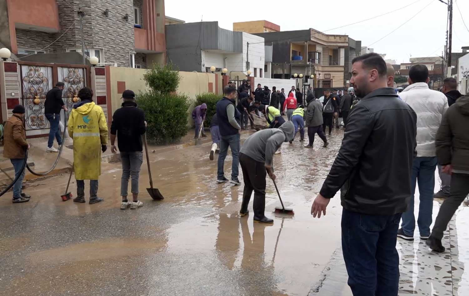 Municipal teams and local residents clear debris from the alleys of Shekhan district in Duhok following heavy flooding on February 8, 2026.