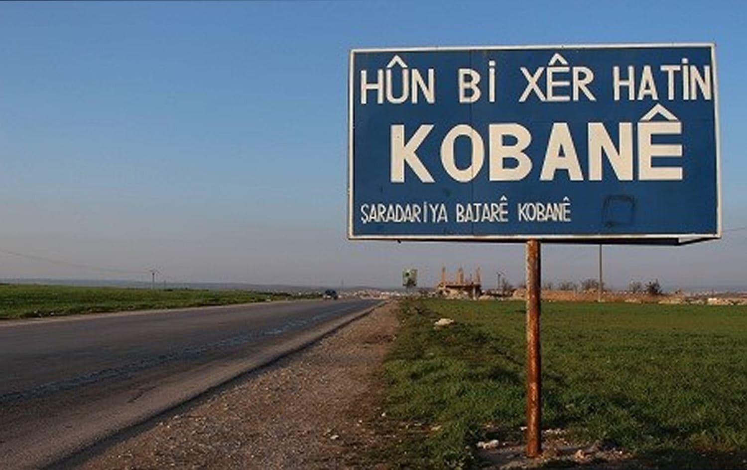 A billboard on the outskirts of Kobane in northeast Syria (Rojava) reads: 'Welcome to Kobane, the municipality of Kobane' on February 25, 2019. Photo: Hannah Lynch / Rudaw