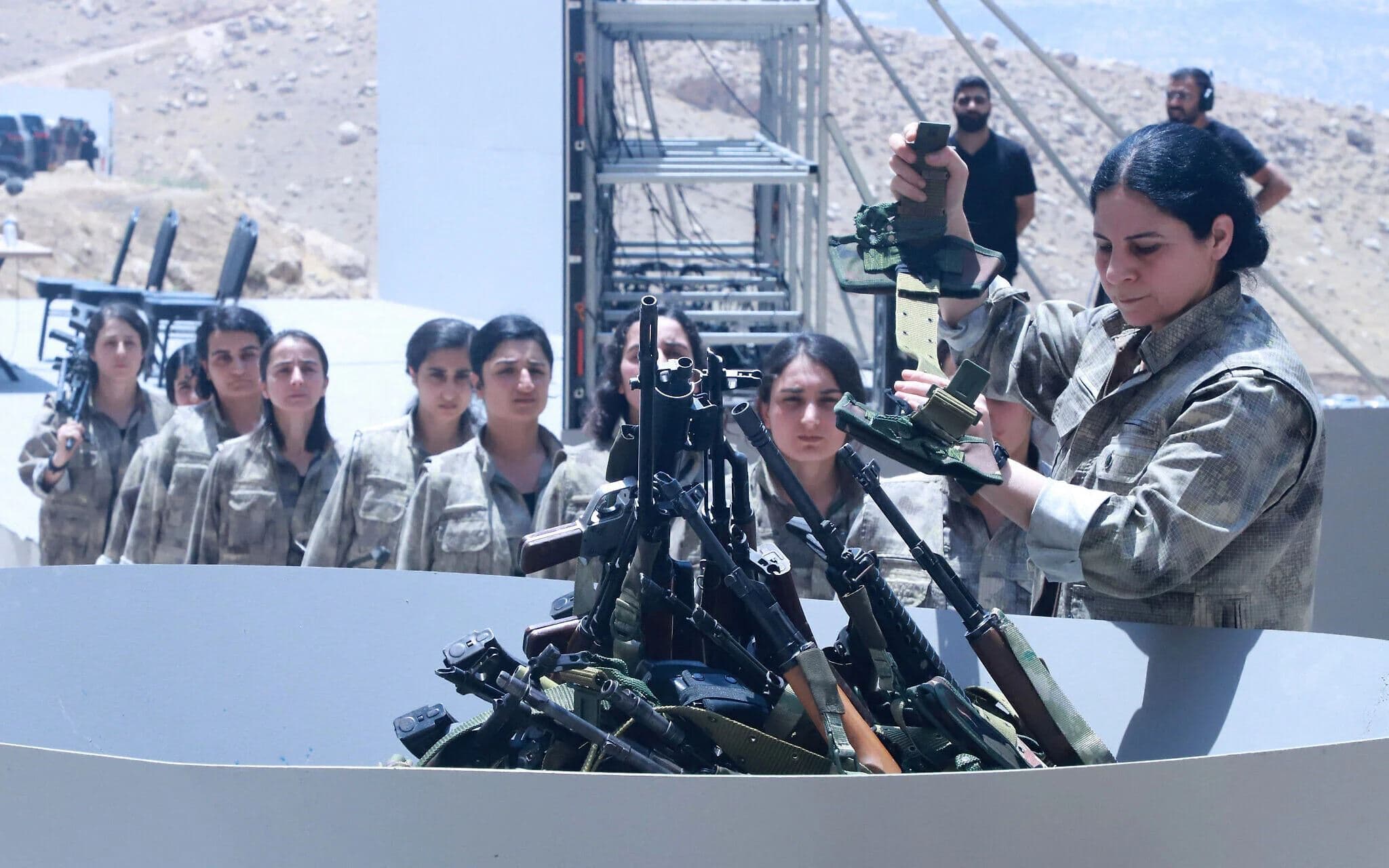 Fighters with the Kurdistan Workers' Party (PKK) line up to put their weapons into a pit during a ceremony in Sulaimaniyah, in Iraq's autonomous Kurdistan region, on July 11, 2025. AFP file photo
