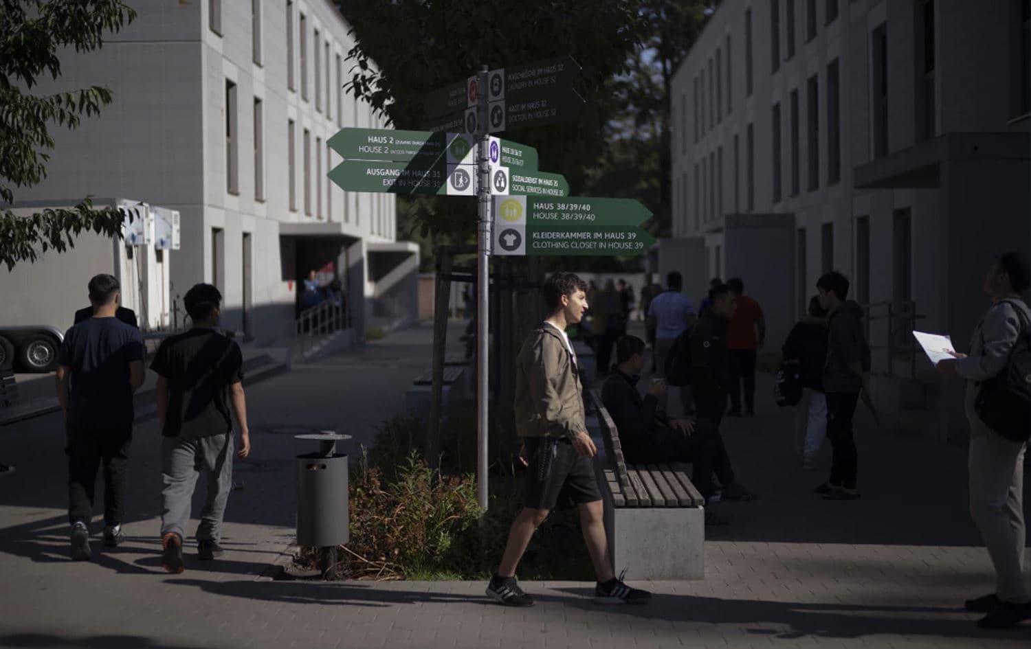 Service signs in German and English stand between shelter buildings for asylum seekers in Berlin, Germany, on September 25, 2023. Photo: Markus Schreiber / AP