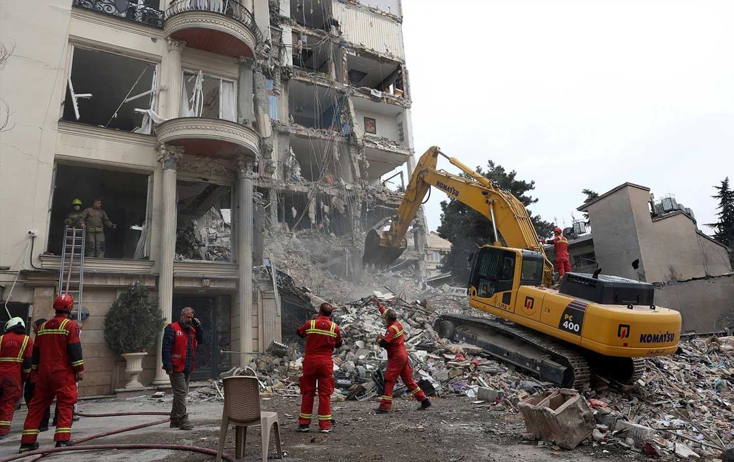 Iranian firefighters clear rubble from a destroyed residential building in northern Tehran on March 23, 2026. File photo: AFP