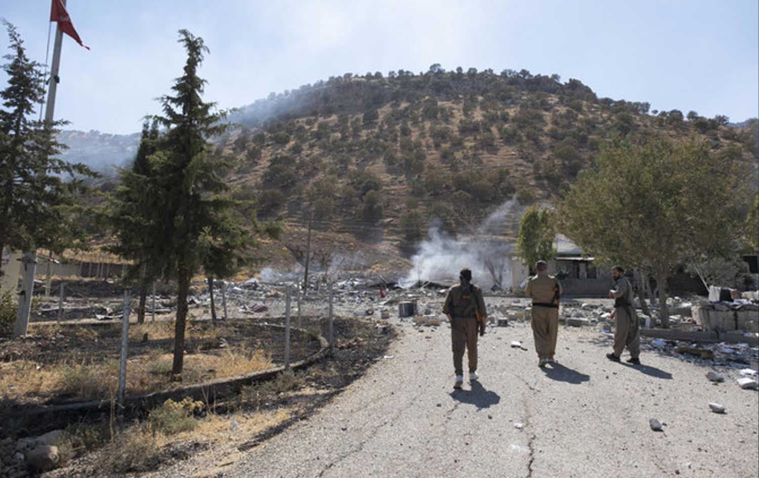 Members of Komala party inspect aftermath of bombing in the village of Zrgoiz, near Sulaimani, on September 28, 2022. File photo: AP