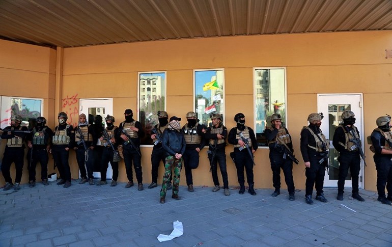 Iraqi security forces stand guard in front of the U.S. embassy in Baghdad, Iraq, Tuesday, Dec. 31, 2019. Photo via AP/Khalid Mohammed)