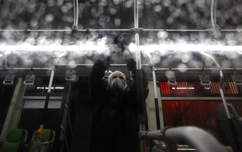  A Tehran municipality worker cleans a bus to avoid the spread of the COVID-19 illness on February 26, 2020. Photo: Atta Kenare / AFP