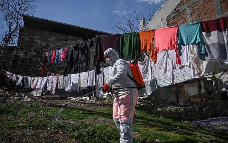 A member of the Fatih Municipality disinfects a garden at a home in Istanbul to prevent the spread of the novel coronavirus on March 20, 2020. Photo: Ozan Kose/AFP