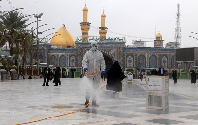 Iraqi health workers disinfect the area around the Imam Hussein Shrine in Karbala on March 15, 2020 amidst efforts against the spread of COVID-19 coronavirus disease. Photo: Mohammed Sawaf/AFP
