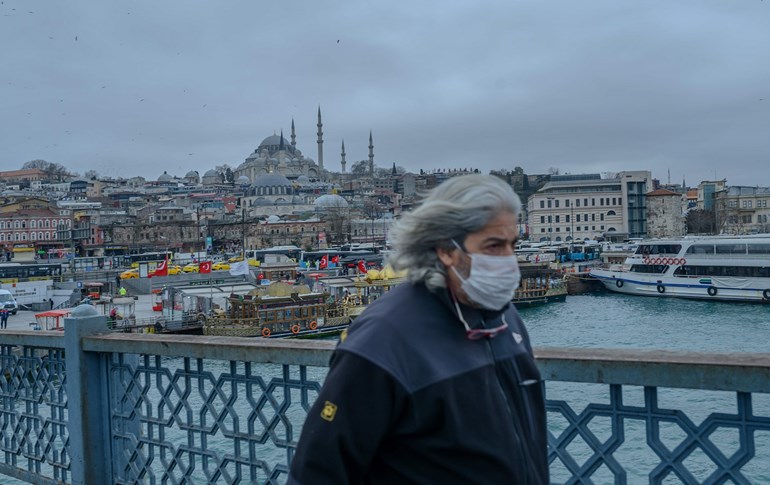  A man walks across Galata bridge in central Istanbul, deserted due to the novel coronavirus, on March 26, 2020. Photo: Bulent Kilic / AFP 